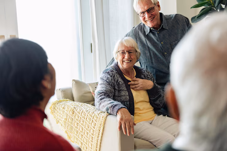 Group of residents enjoying conversation in a cozy living room