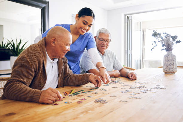 Caregiver and residents doing a puzzle together